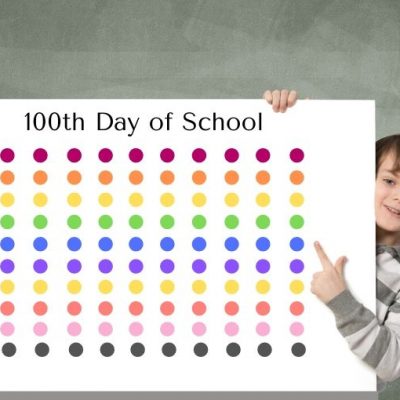 boy with poster with 100 dots of multiple colors