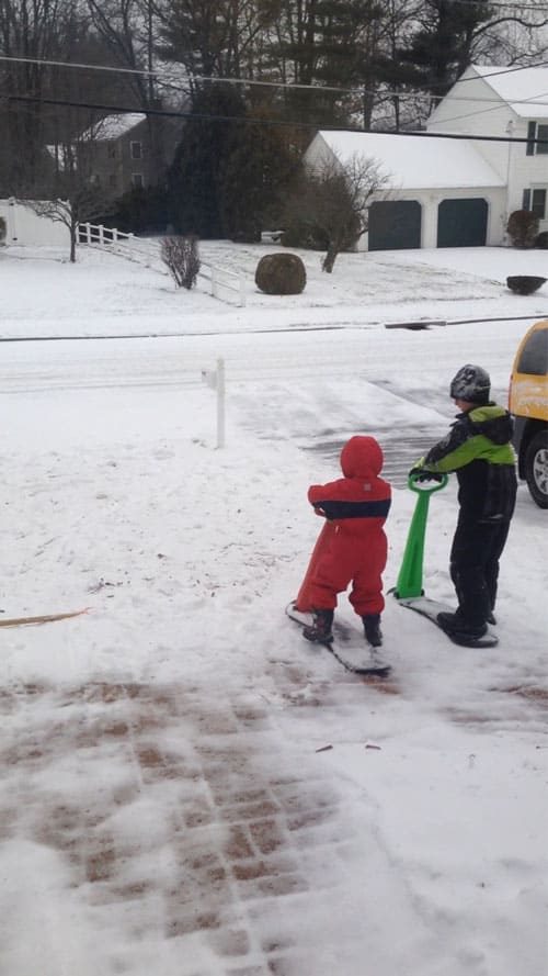 children on ski scooters outside in the snow 