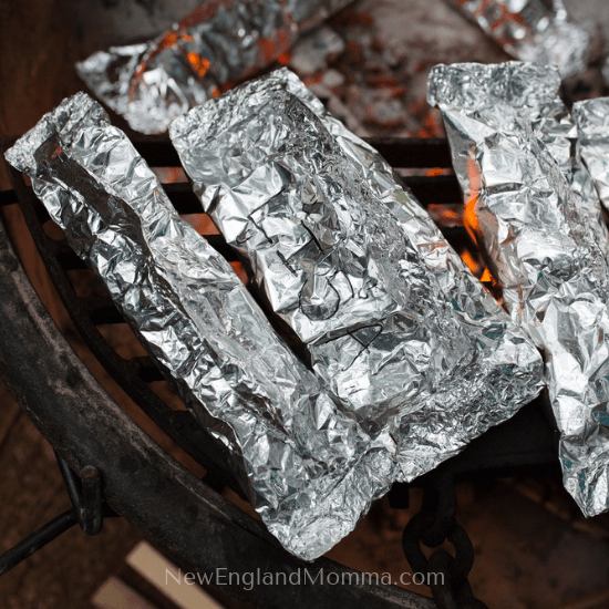 food wrapped in aluminum foil on a grill