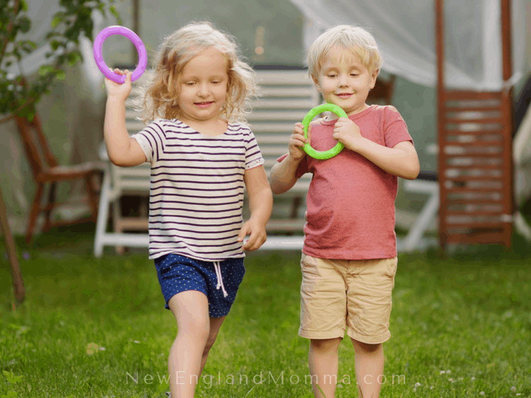 Two kids playing ring toss - playing games while camping