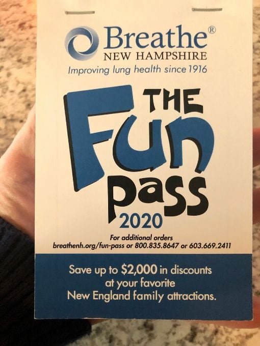 a coupon book called the fun pass in a person's hand