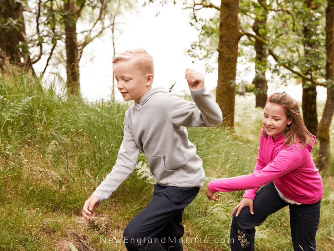 2 kids running in the woods