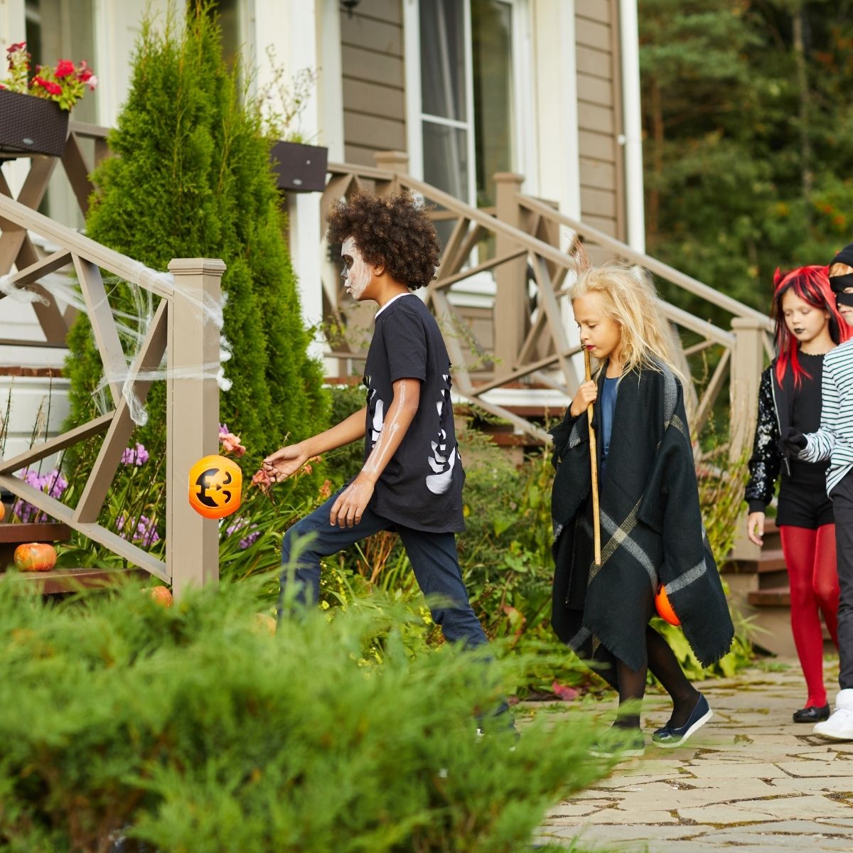 kids dressed up going trick or treating together
