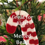 homemade candy cane ornament hanging on a christmas tree branch