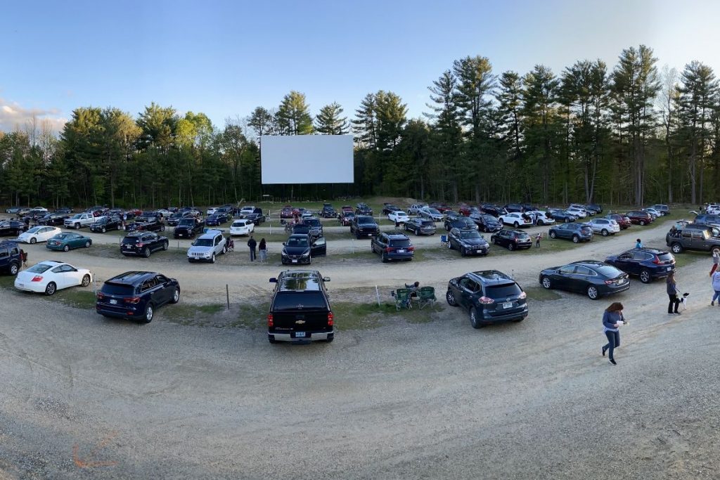 Cards spaced out at a drive-in movie theatre 