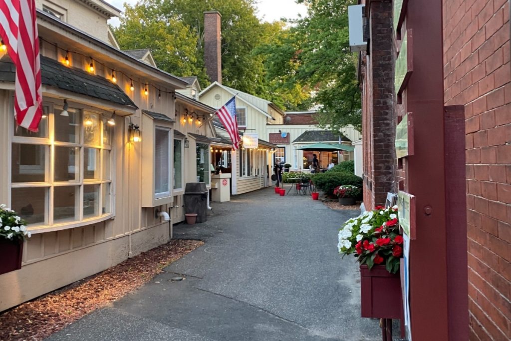 Small alley view of a cute restaurant with outdoor seating in Stockbridge. 