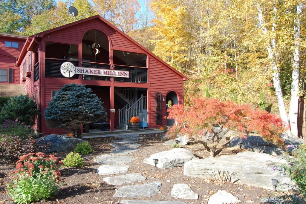 The red building of the Shaker Mill Inn in the fall time - fun for a weekend in the Berkshires