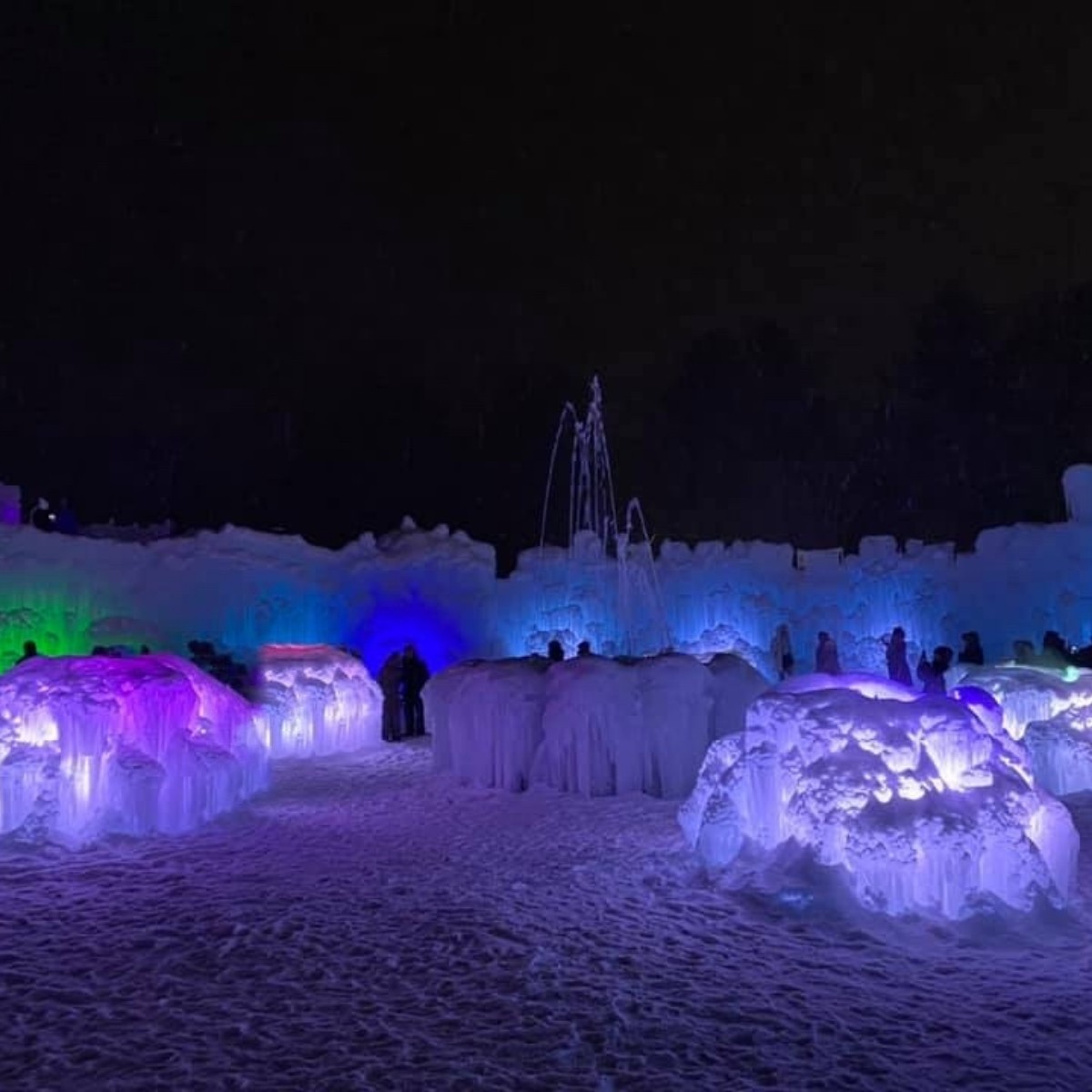 The Ice Castles at night all aglow in purples and blues. 